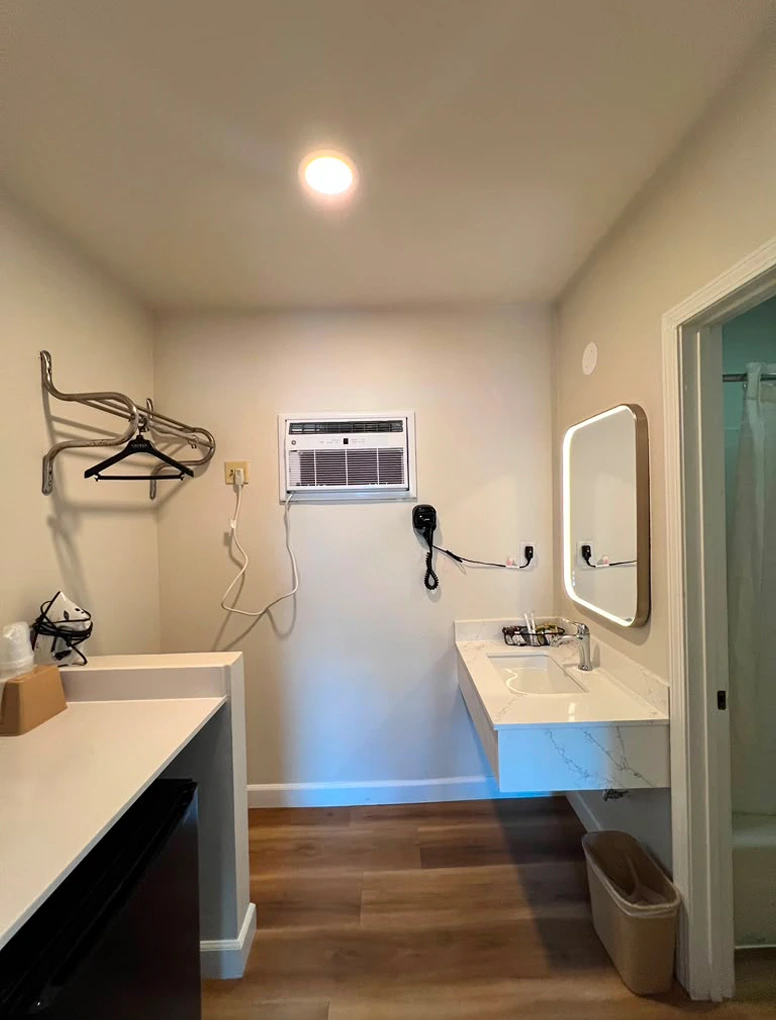 Bathroom vanity and wall-mounted amenities in a Friendship Motor Inn guest room