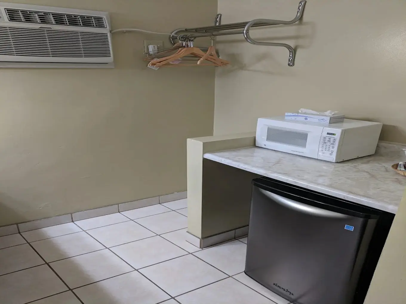 In-room microwave, mini-refrigerator, clothes rack, and air conditioner